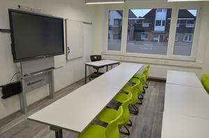 Das Foto zeigt den kleineren der beiden VHS-Unterrichtsräume mit seinen 10 Schülerplätzen und dem interaktiven 65 Zoll-Unterrichtsmonitor.